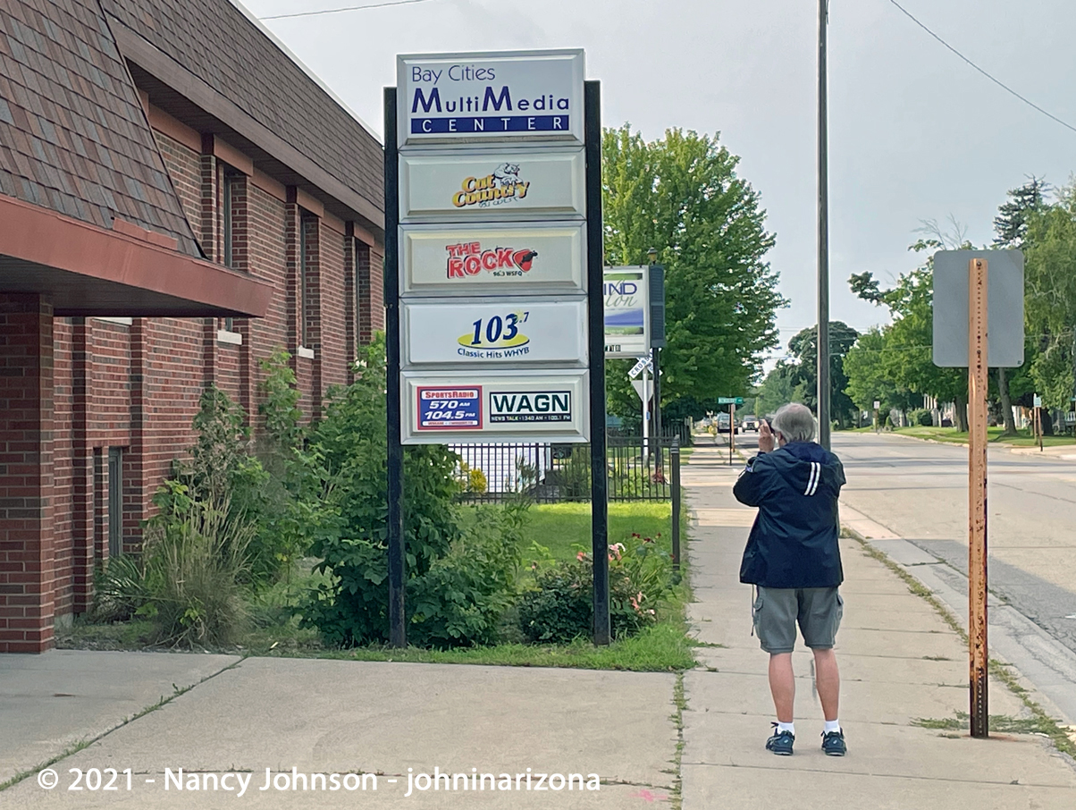 John taking photo of station sign